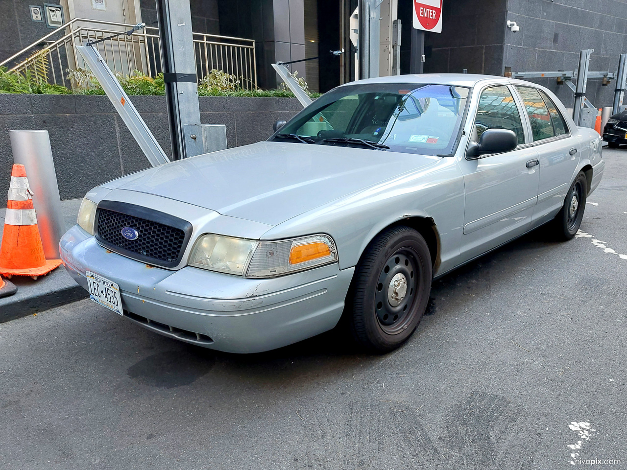 front of a NYPD Ford Crown Victoria Police Interceptor (CVPI)