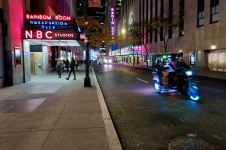 The iconic Radio City by night, 50th street with a pedicab